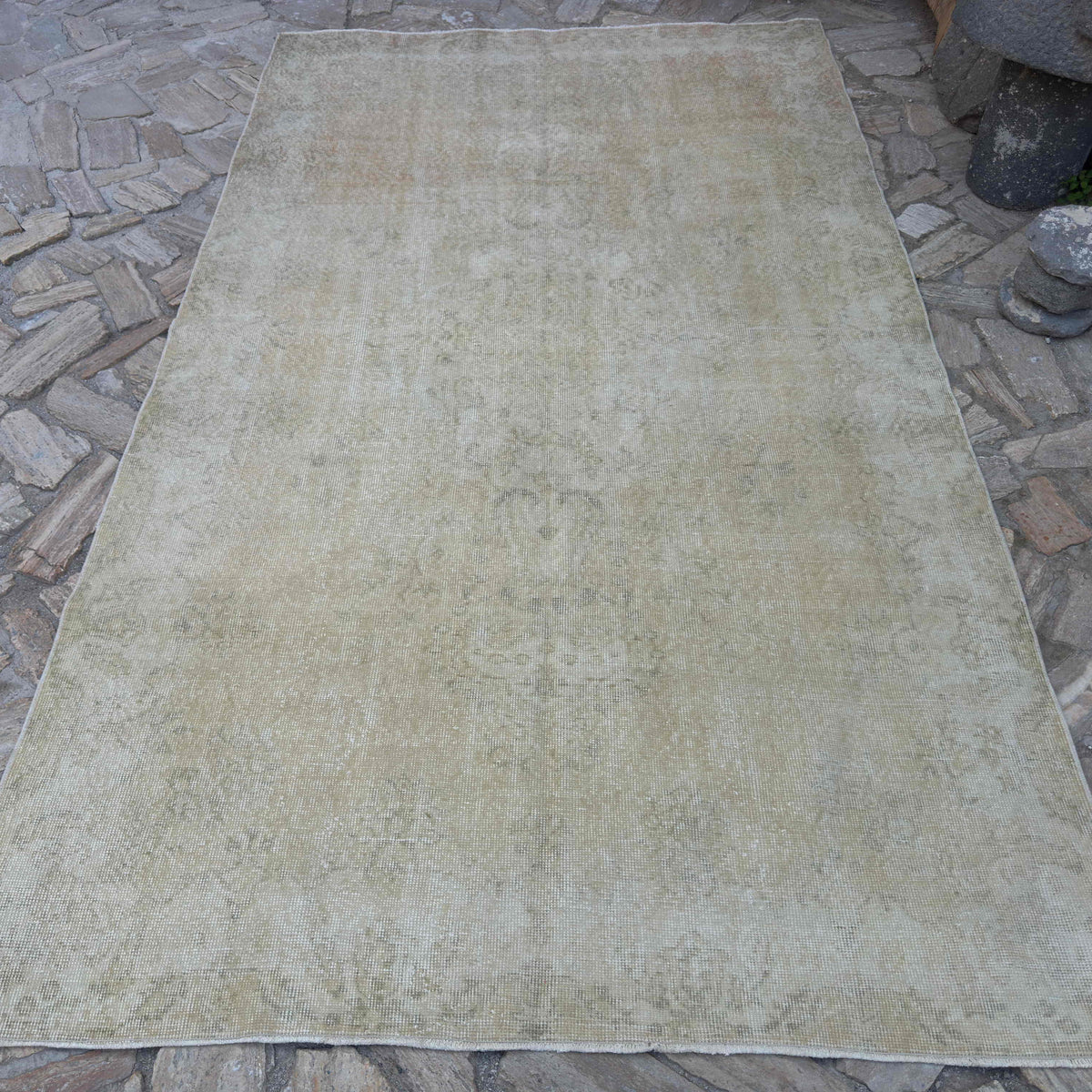 Beige 6' x 10' vintage Turkish distressed rug in wool and cotton, shown on the floor.