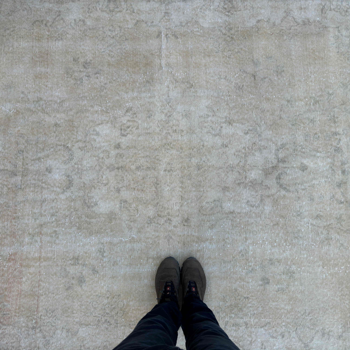1970s beige vintage Turkish distressed rug with neutral design, hand-knotted weave and low pile.