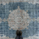 1970s blue vintage Turkish distressed rug with medallion design, hand-knotted weave and low pile.
