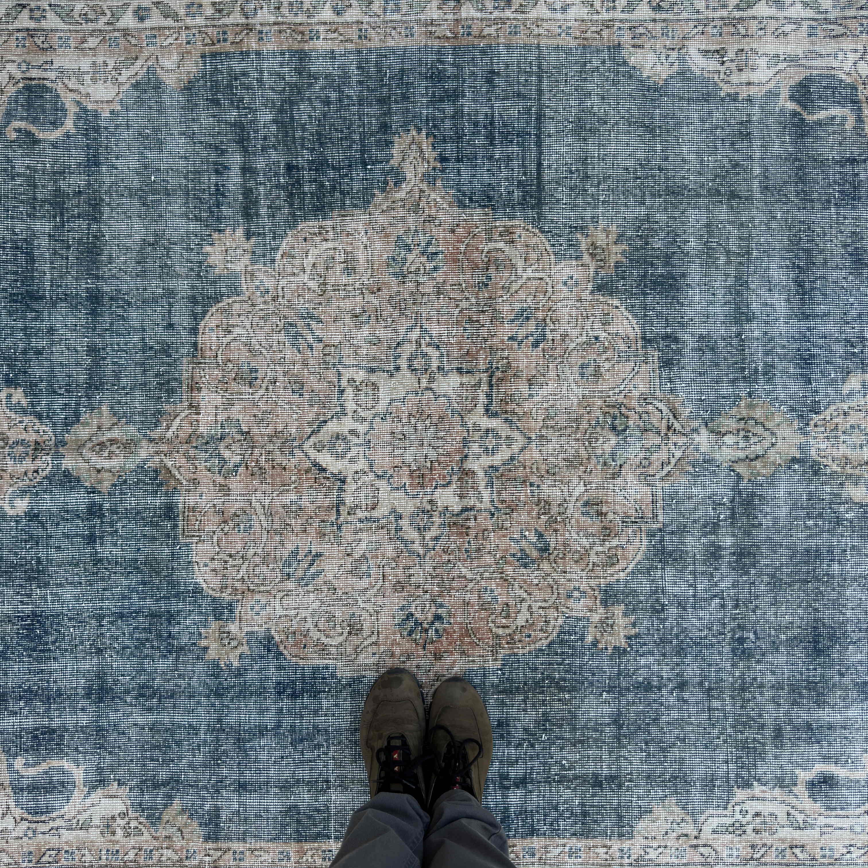 1970s blue vintage Turkish distressed rug with medallion design, hand-knotted weave and low pile.