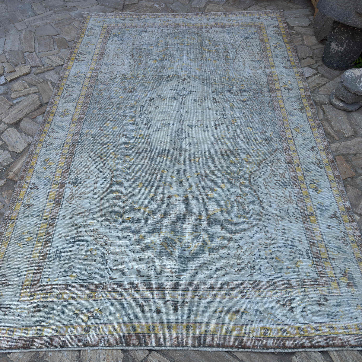 Blue 6' x 10' vintage Turkish distressed rug in wool and cotton, shown on the floor.