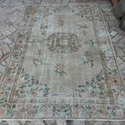 Beige 6' x 8' vintage Turkish distressed rug in wool and cotton, shown on the floor.