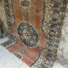 Orange 6' x 8' vintage Turkish distressed rug in wool and cotton, shown on the floor.