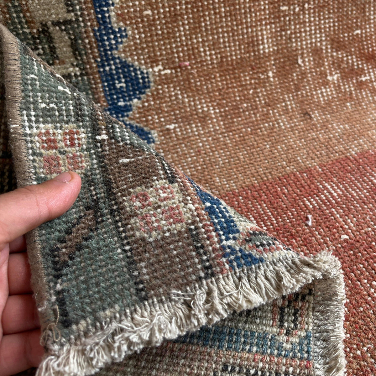 1970s orange vintage Turkish distressed rug with traditional design, hand-knotted weave and low pile.