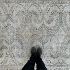 1970s beige vintage Turkish distressed rug with neutral design, hand-knotted weave and low pile.