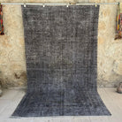 Black 6' x 9' vintage distressed rug with overdyed design, handmade in Turkey – Calvin.