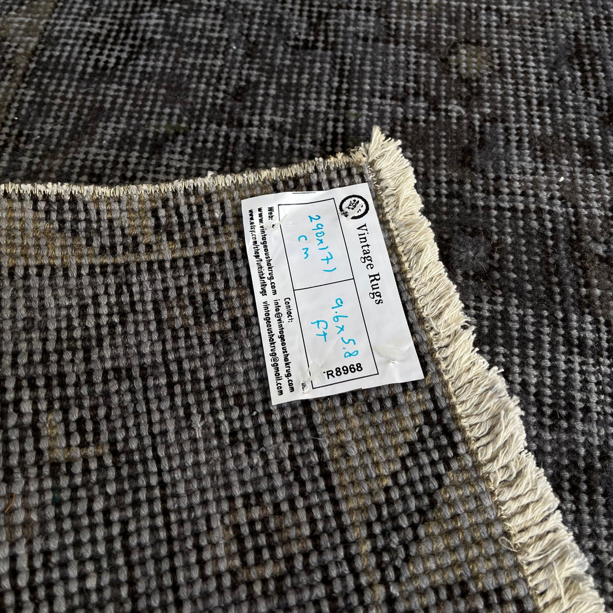 1970s black vintage Turkish distressed rug with overdyed design, hand-knotted weave and low pile.