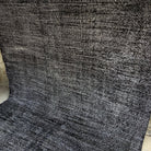 Black 6' x 9' vintage Turkish distressed rug in wool and cotton, shown on the floor.