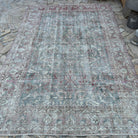 Pale Green 7' x 10' vintage Turkish distressed rug in wool and cotton, shown on the floor.