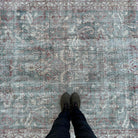 1970s pale green vintage Turkish distressed rug with traditional design, hand-knotted weave and low pile.