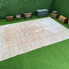 Pale Pink 8' x 11' vintage distressed rug with floral design, handmade in Turkey – York.