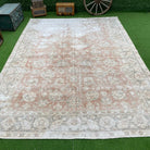Pale Pink 8' x 11' vintage Turkish distressed rug in wool and cotton, shown on the floor.