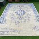 Blue 9' x 12' vintage Turkish distressed rug in wool and cotton, shown on the floor.