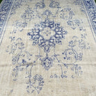 1970s blue vintage Turkish distressed rug with medallion design, hand-knotted weave and low pile.