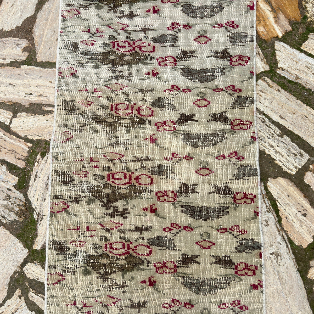 1970s green vintage Turkish distressed runner rug with floral design, hand-knotted weave and low pile.