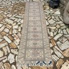 Beige 3' x 10' vintage Turkish distressed runner rug in wool and cotton, shown on the floor.