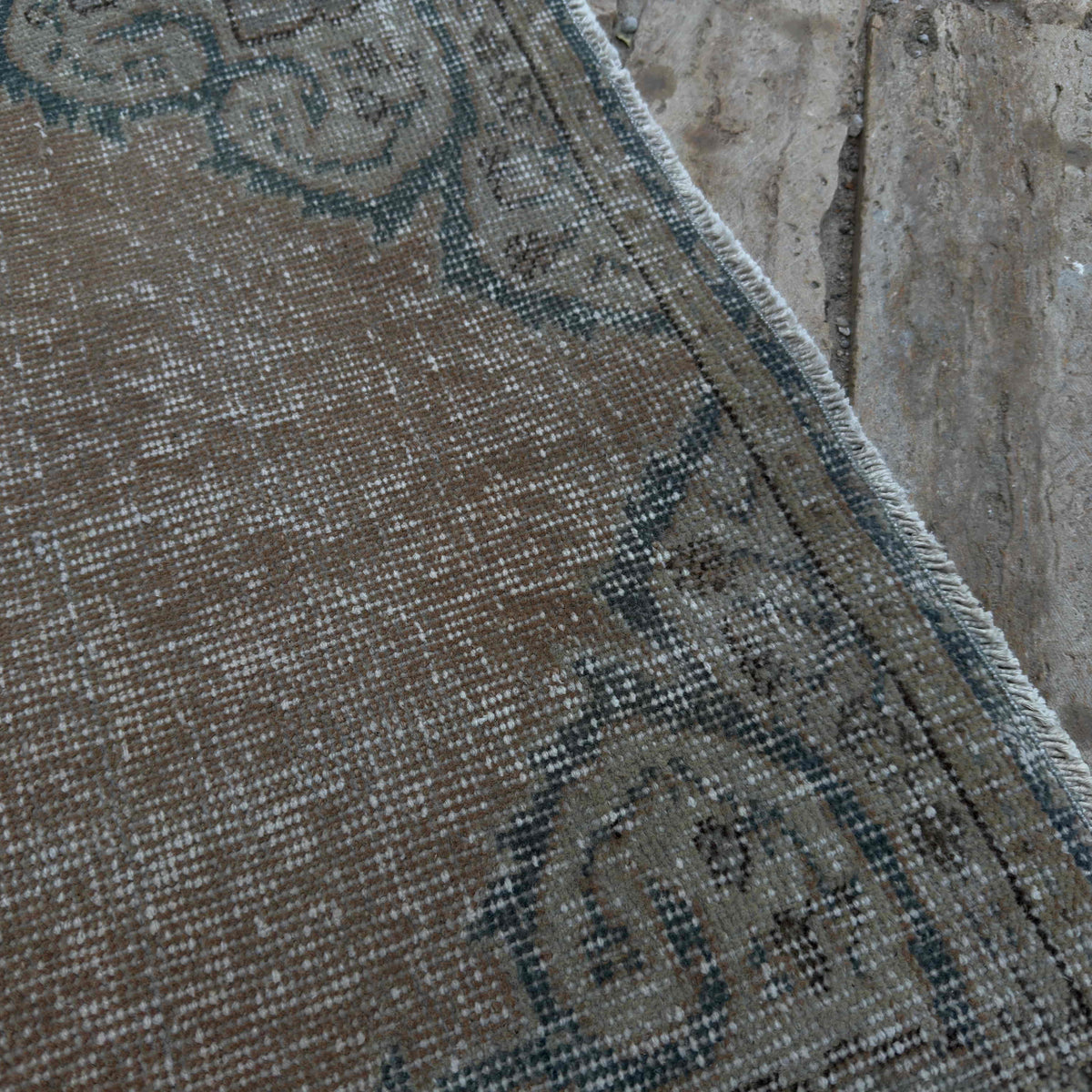 Close-up of the beige vintage Turkish distressed runner rug showing traditional details, hand-knotted weave, wool and cotton and low pile.