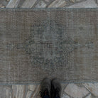 1970s beige vintage Turkish distressed runner rug with traditional design, hand-knotted weave and low pile.