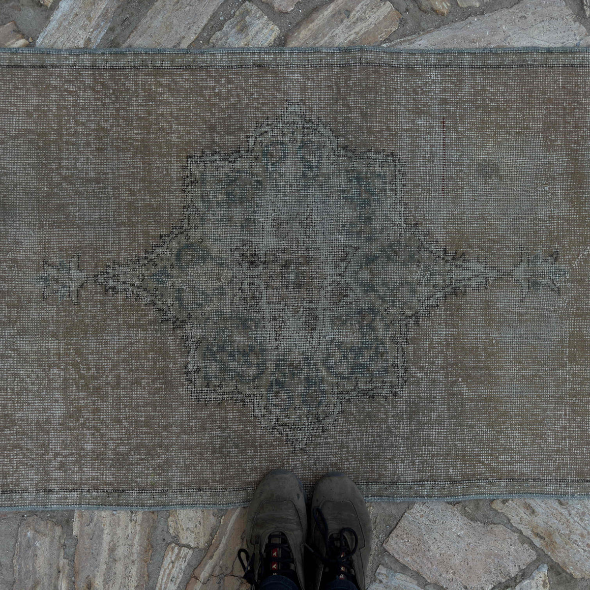 1970s beige vintage Turkish distressed runner rug with traditional design, hand-knotted weave and low pile.