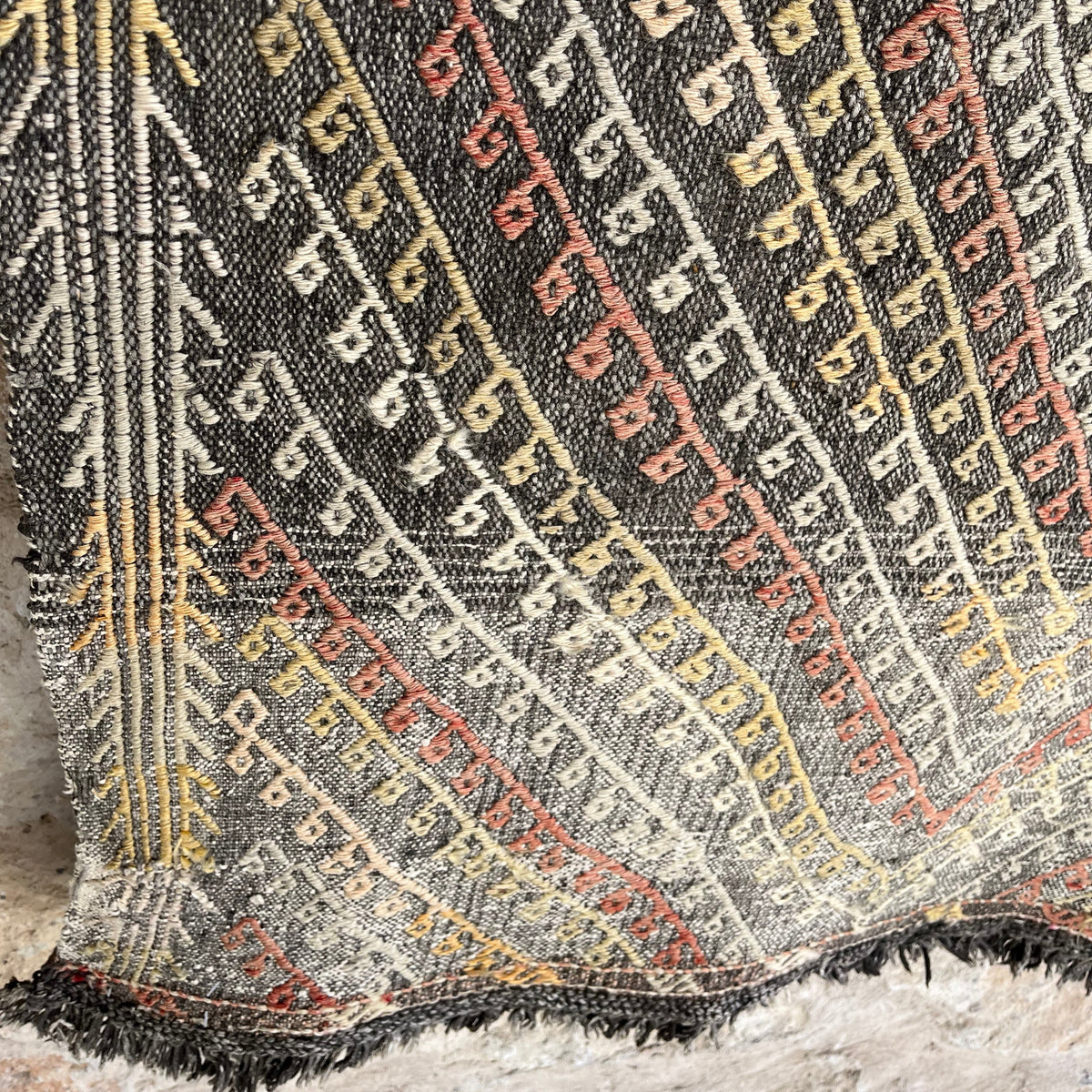 Close-up of the black vintage Turkish flatweave rug showing traditional details, flatweave construction, wool and cotton and low pile.