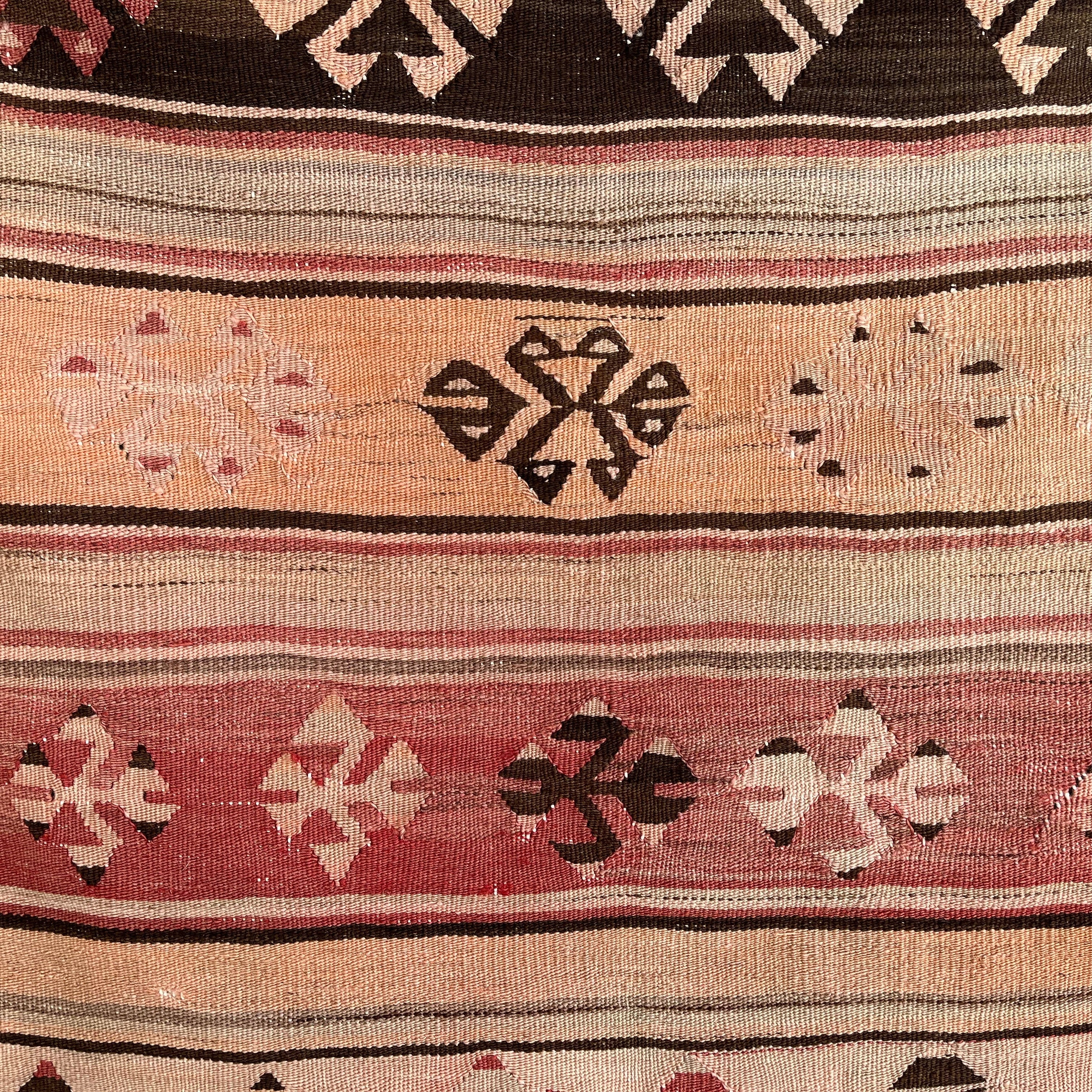 Close-up of the red vintage Turkish flatweave rug showing traditional details, flatweave construction, wool and cotton and low pile.