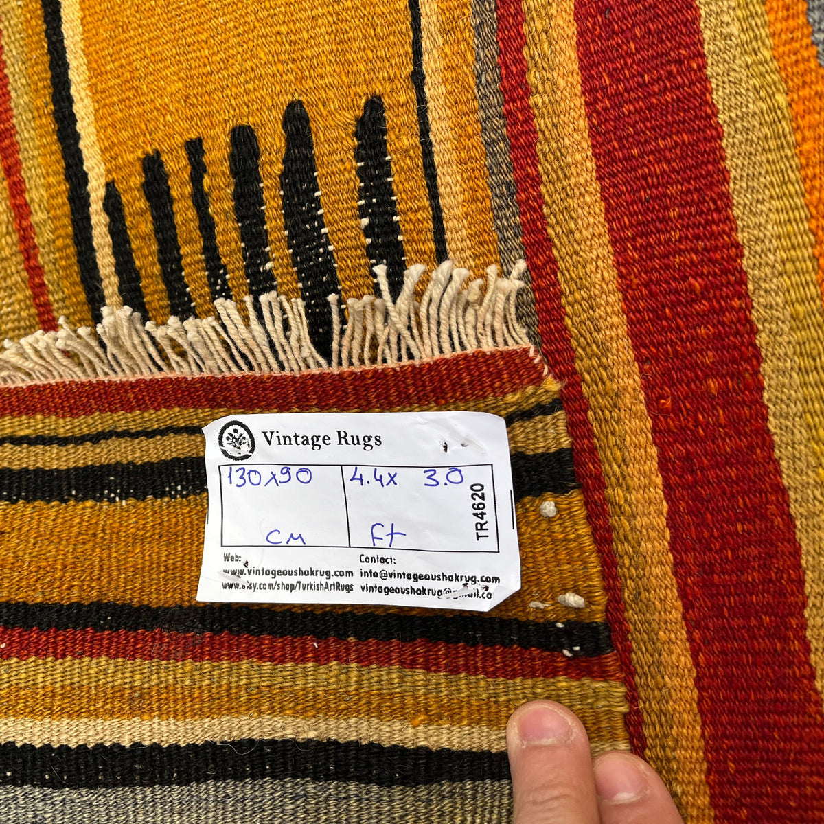 Close-up of the yellow vintage Turkish flatweave rug showing traditional details, flatweave construction, wool and cotton and low pile.