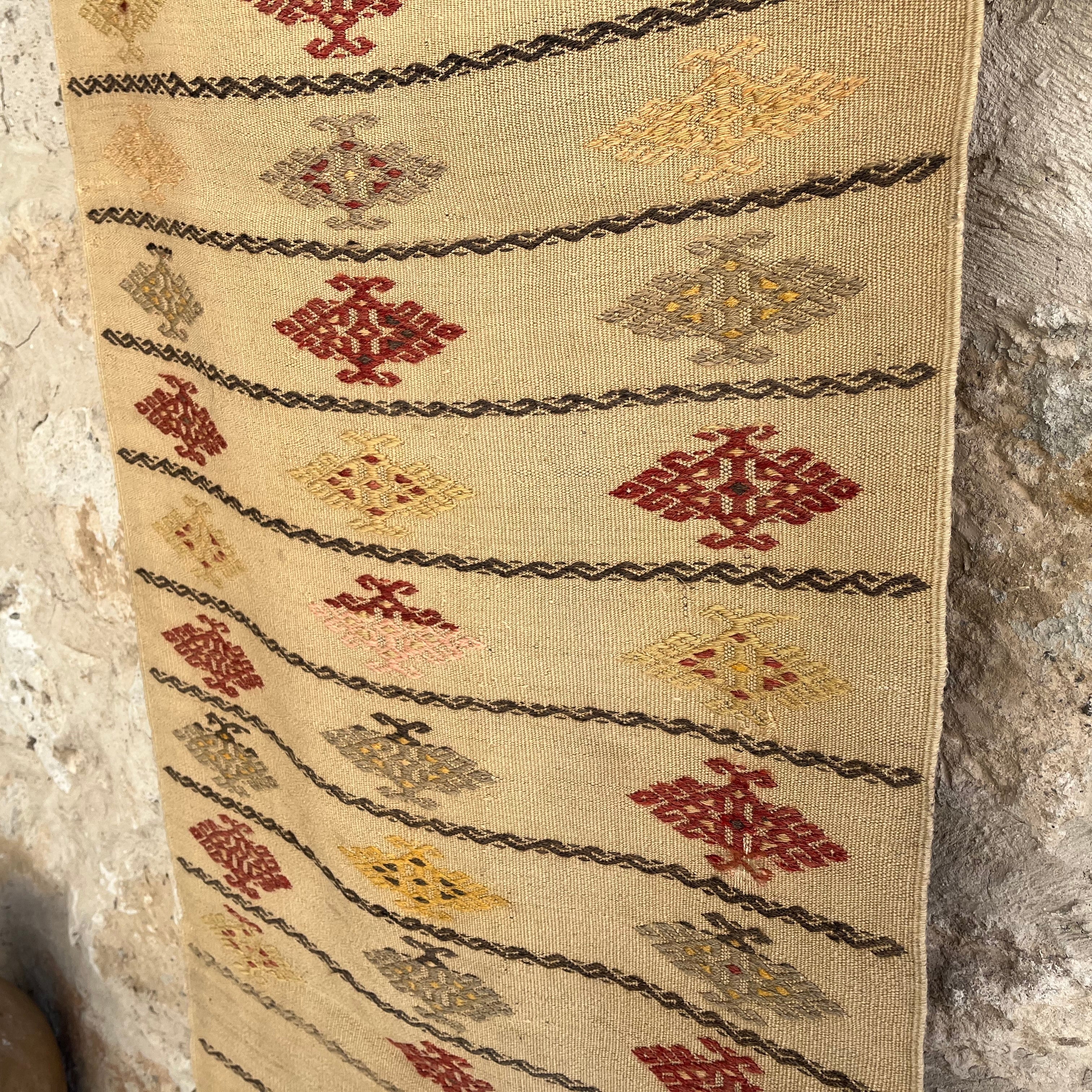 Close-up of the beige vintage Turkish flatweave runner rug showing traditional details, flatweave construction, wool and cotton and low pile.