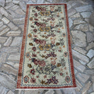 Red 3' x 5' vintage Turkish floral rug in wool and cotton, shown on the floor.