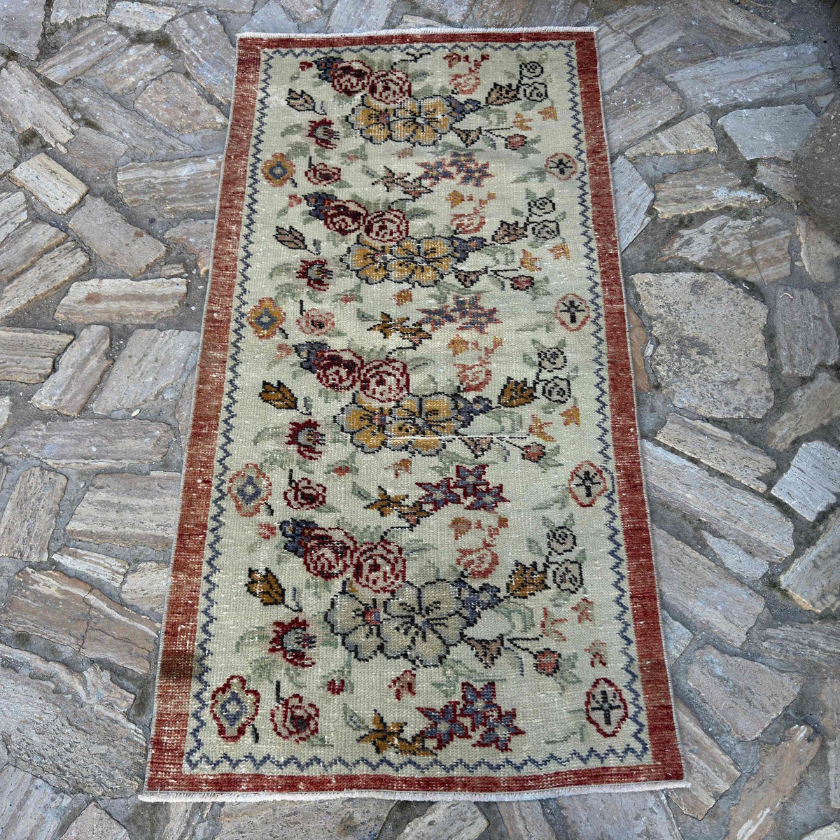 Red 3' x 5' vintage Turkish floral rug in wool and cotton, shown on the floor.