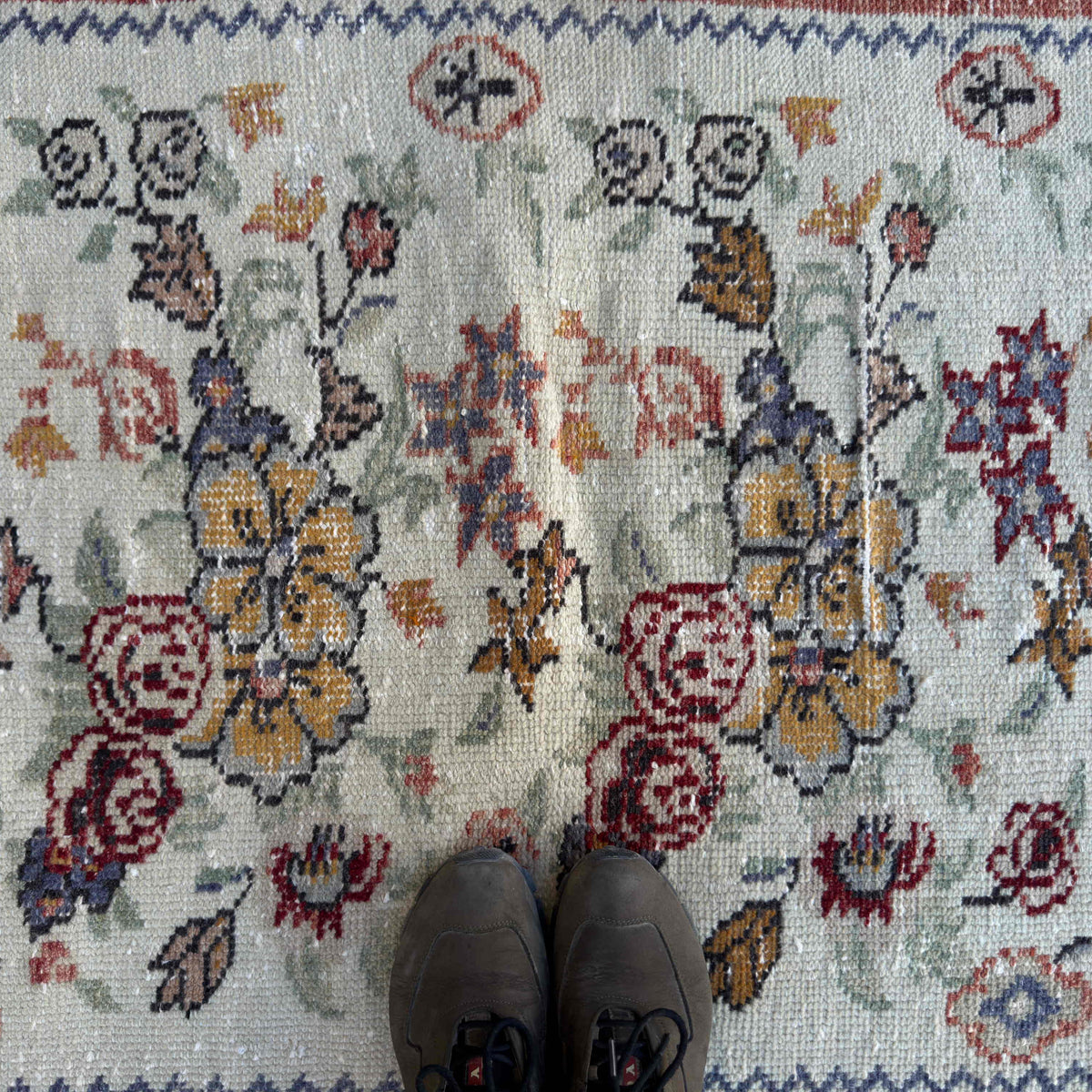 1970s red vintage Turkish floral rug with floral design, hand-knotted weave and low pile.
