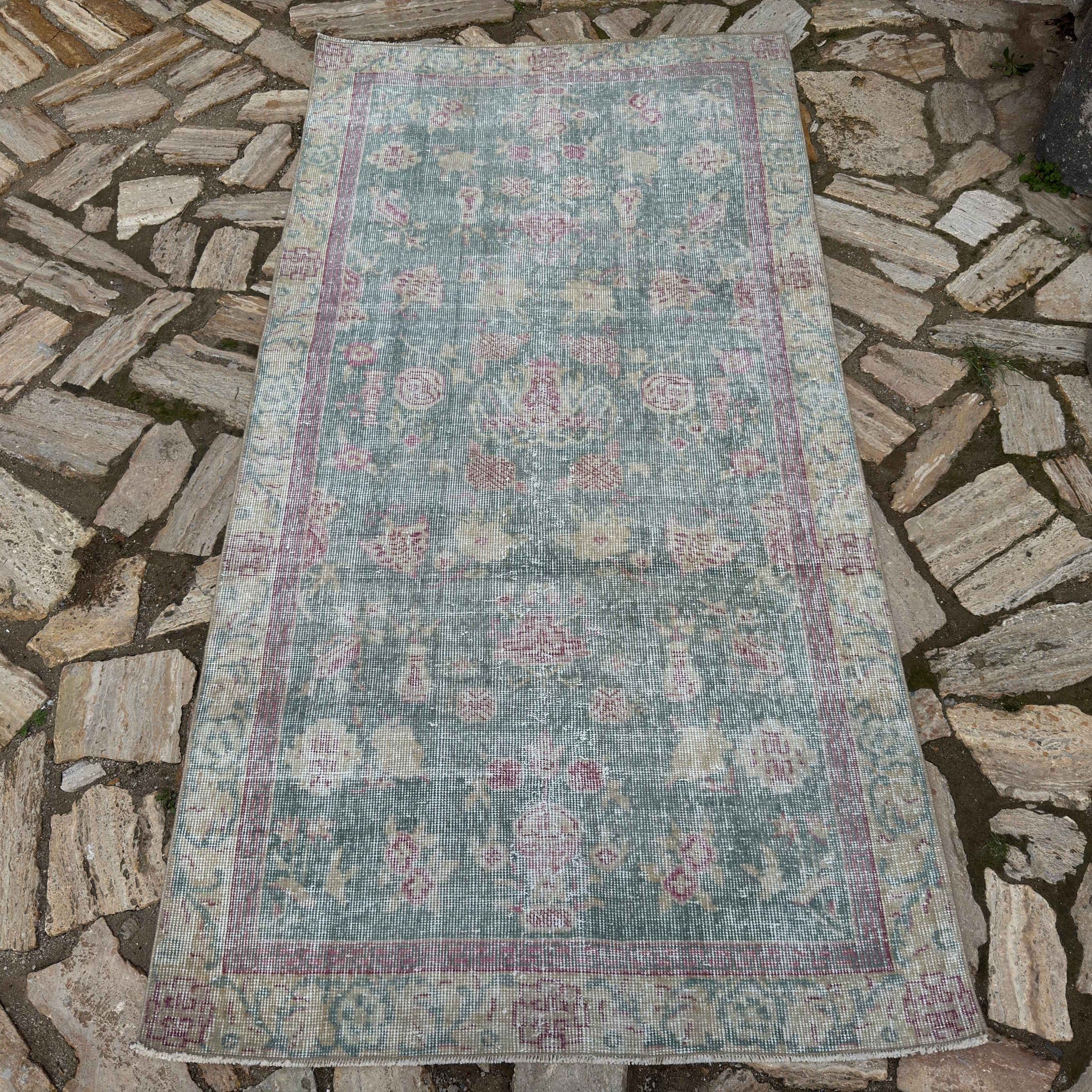 Pale Blue 3' x 6' vintage Turkish floral rug in wool and cotton, shown on the floor.