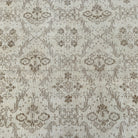 1970s beige vintage Turkish floral rug with geometric design, hand-knotted weave and low pile.
