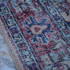 Red 4' x 7' vintage Turkish floral rug in wool and cotton, shown on the floor.