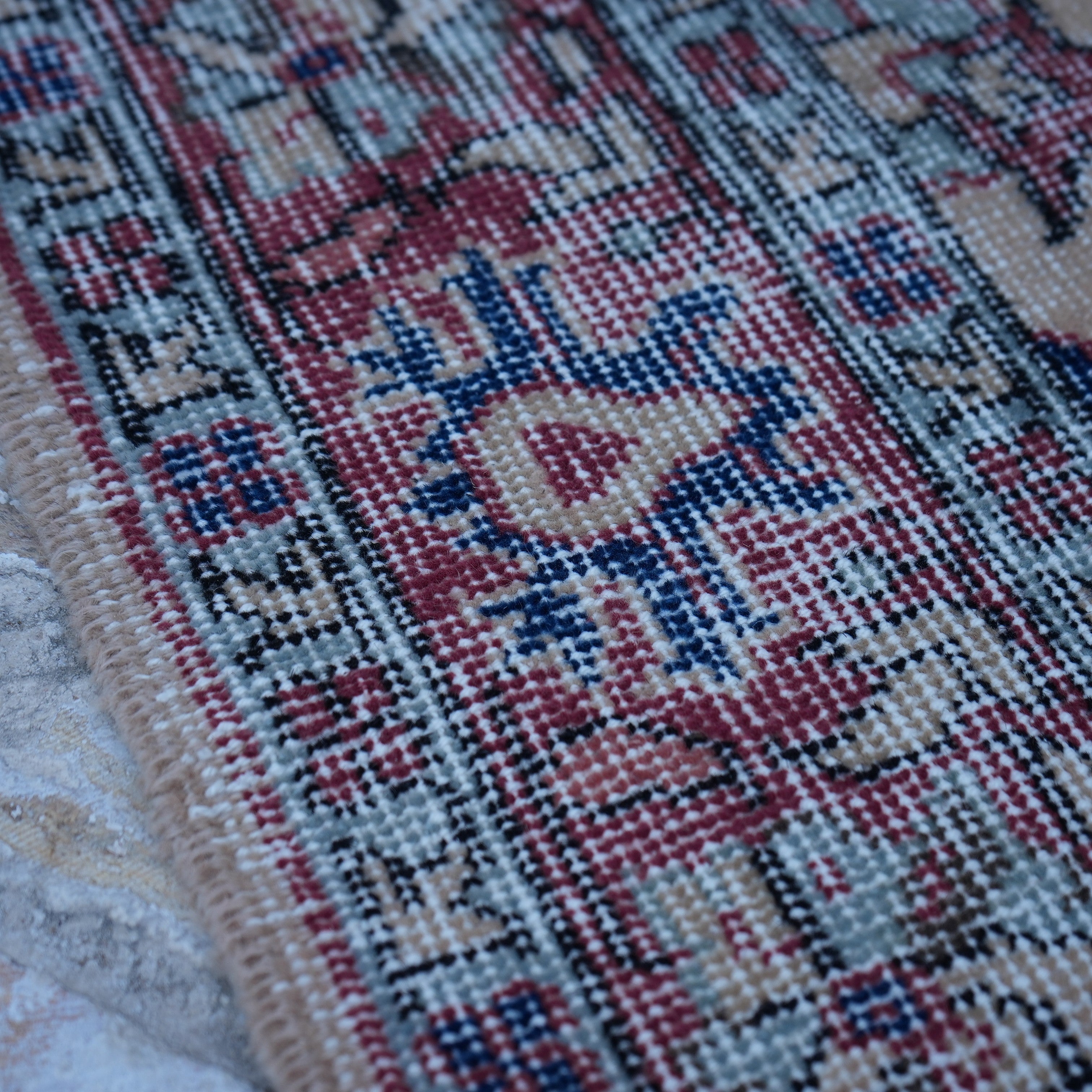 Red 4' x 7' vintage Turkish floral rug in wool and cotton, shown on the floor.