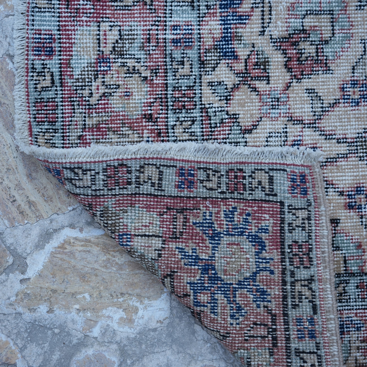 1970s red vintage Turkish floral rug with floral design, hand-knotted weave and low pile.