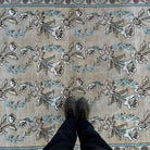 1970s beige vintage Turkish floral rug with floral design, hand-knotted weave and low pile.