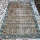 Orange 5' x 8' vintage Turkish floral rug in wool and cotton, shown on the floor.