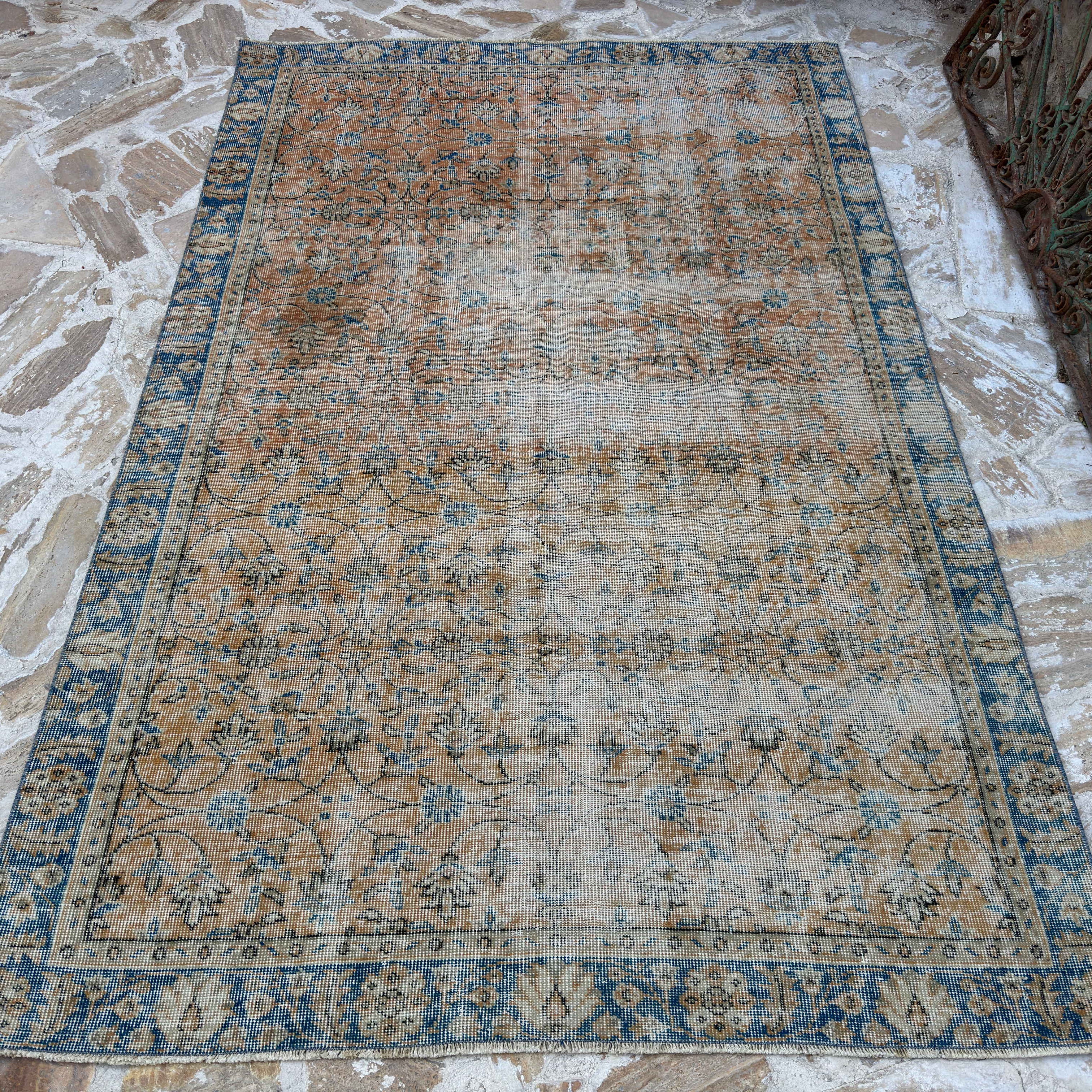 Orange 5' x 8' vintage Turkish floral rug in wool and cotton, shown on the floor.
