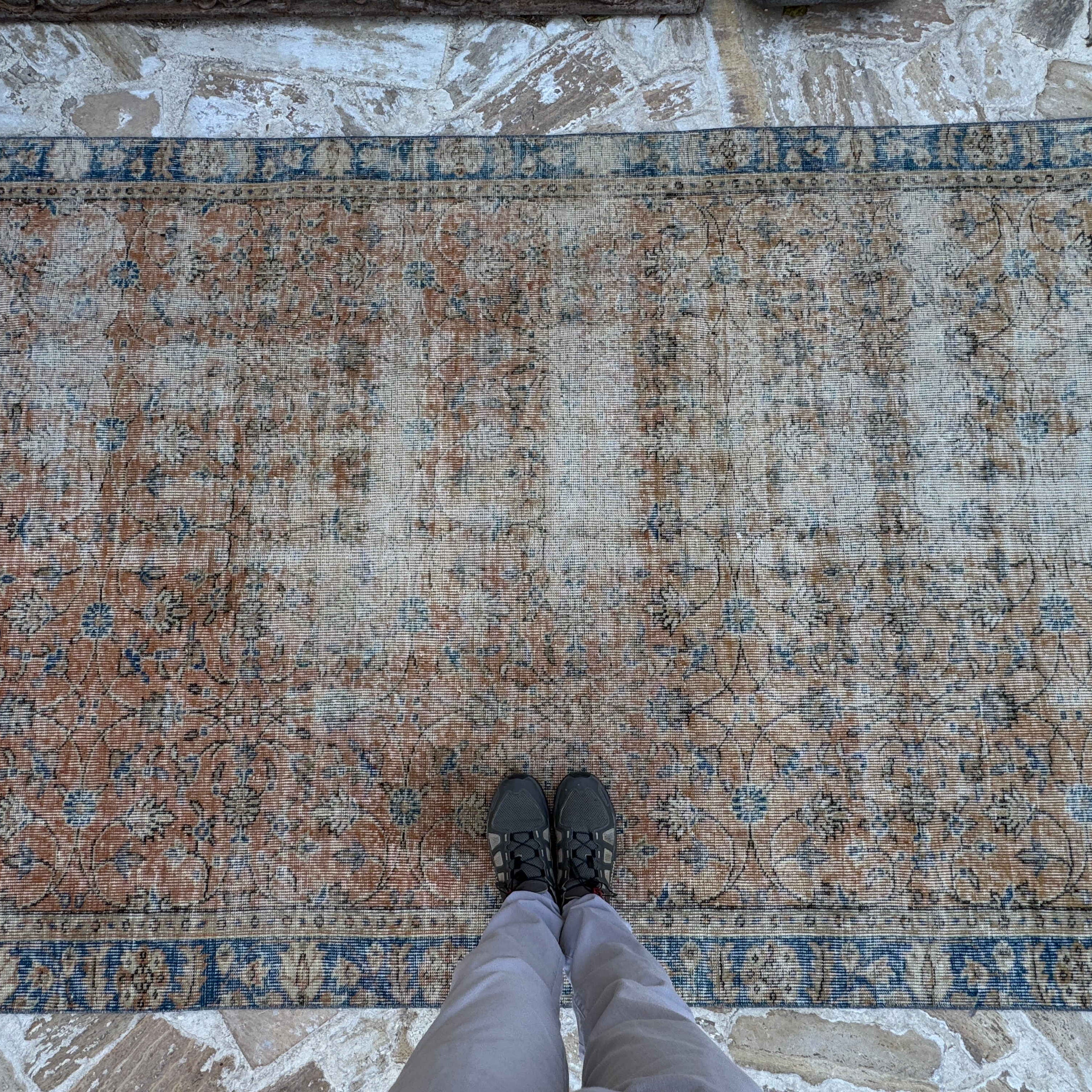 1970s orange vintage Turkish floral rug with floral design, hand-knotted weave and low pile.