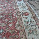 Close-up of the pink vintage Turkish floral rug showing floral details, hand-knotted weave, wool and cotton and low pile.