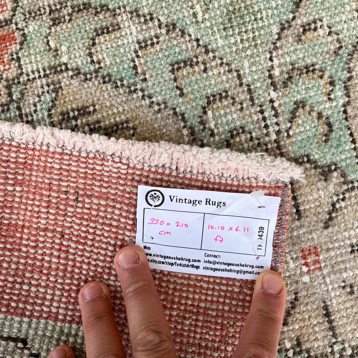 1970s pale green vintage Turkish floral rug with floral design, hand-knotted weave and low pile.
