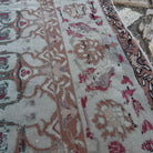 Close-up of the gray vintage Turkish floral rug showing floral details, hand-knotted weave, wool and cotton and low pile.