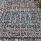 Gray 7' x 9' vintage Turkish floral rug in wool and cotton, shown on the floor.