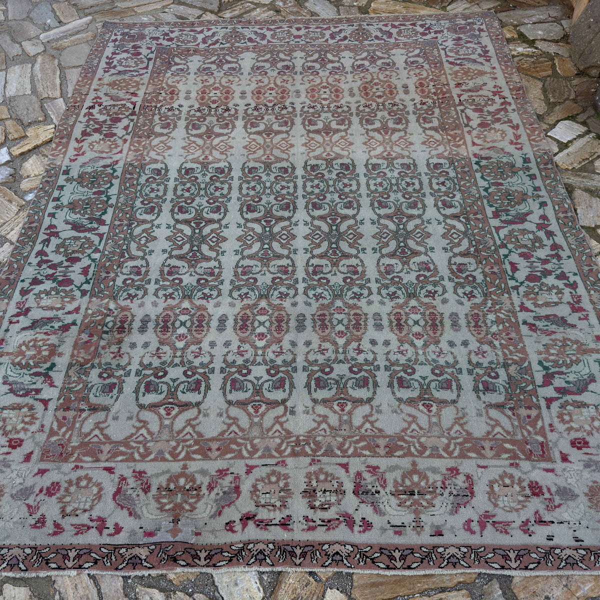 Gray 7' x 9' vintage Turkish floral rug in wool and cotton, shown on the floor.