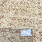 Close-up of the brown vintage Turkish floral rug showing floral details, hand-knotted weave, wool and cotton and low pile.