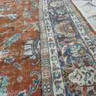 Close-up of the red vintage Turkish floral rug showing floral details, hand-knotted weave, wool and cotton and low pile.