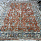 Red 8' x 12' vintage Turkish floral rug in wool and cotton, shown on the floor.