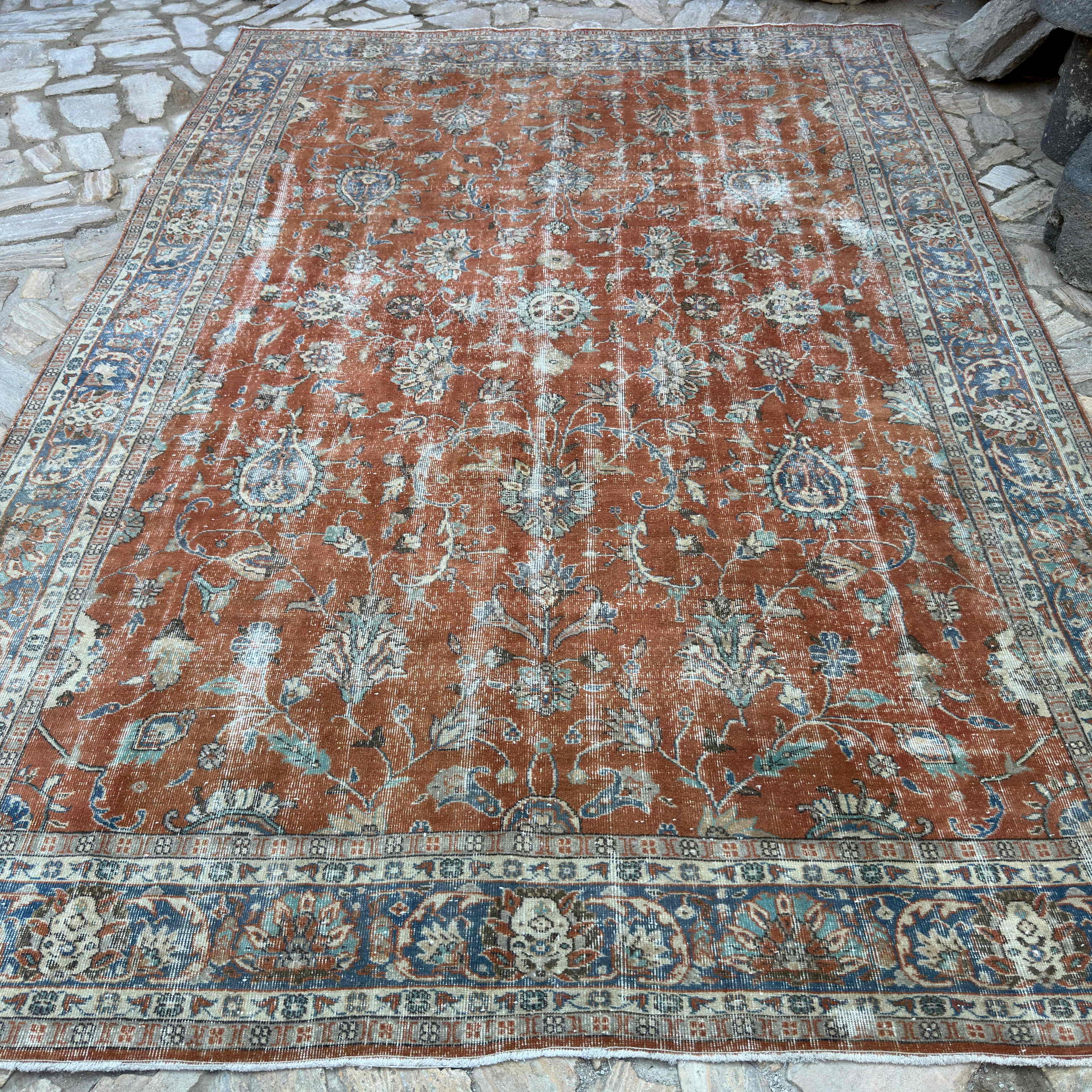 Red 8' x 12' vintage Turkish floral rug in wool and cotton, shown on the floor.