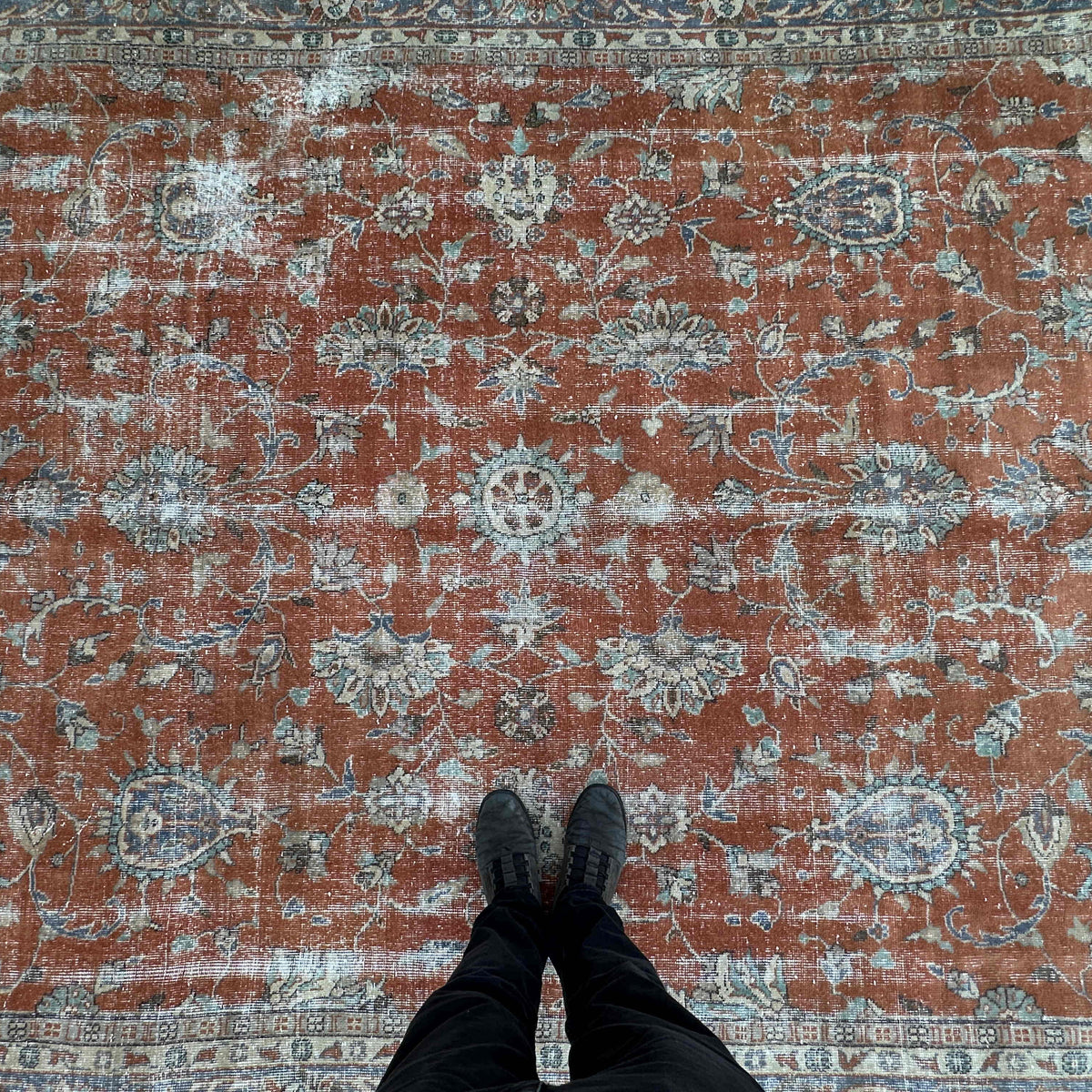 1970s red vintage Turkish floral rug with floral design, hand-knotted weave and low pile.