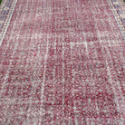 1970s red vintage Turkish floral rug with floral design, hand-knotted weave and low pile.